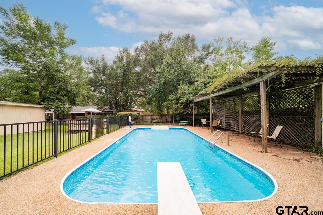 607 Green Oak Drive Longview, TX 75604 - Photo 30 of 48 a view of a swimming pool with a lounge chair