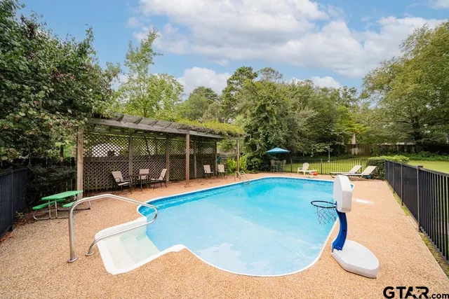 swimming pool with outdoor seating and yard
