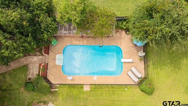 swimming pool view with a seating space