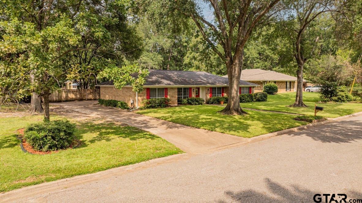 607 Green Oak Drive Longview, TX 75604 - Photo 41 of 48 a front view of a house with a yard