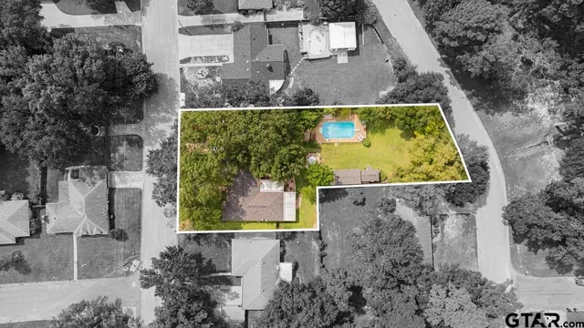 an aerial view of residential house with outdoor space and swimming pool