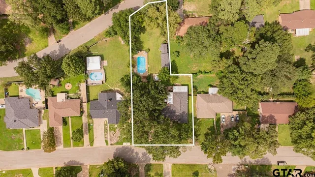 an aerial view of residential houses with outdoor space