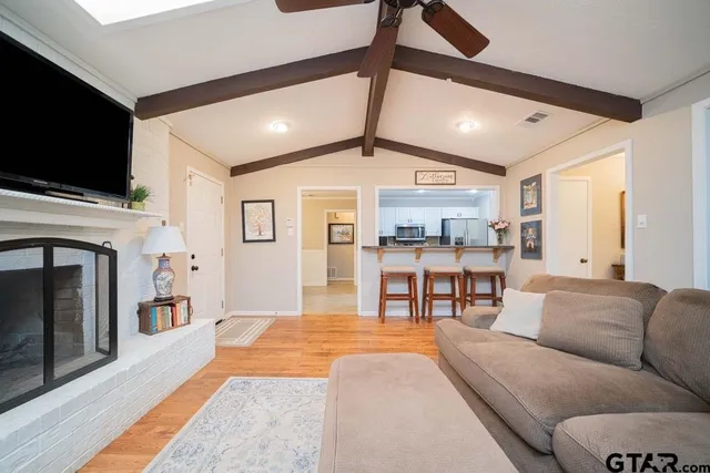 a living room with fireplace furniture and a flat screen tv