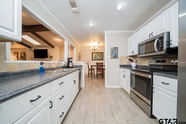 a large kitchen with stainless steel appliances