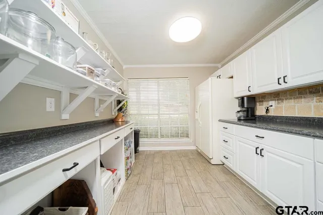 a kitchen with granite countertop white cabinets and white appliances
