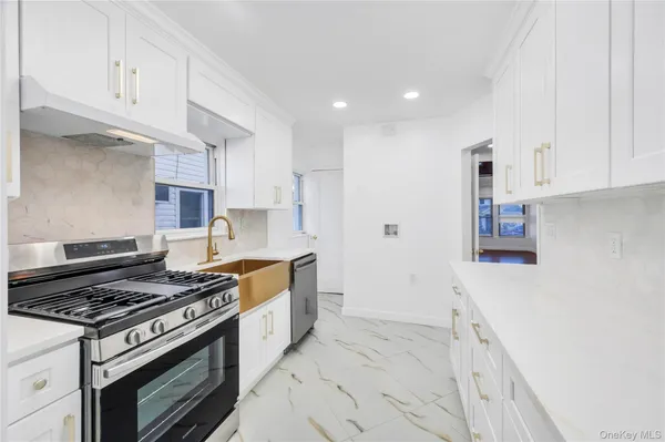 a kitchen with granite countertop a stove and a sink