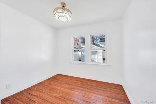 a view of a room with wooden floor and window