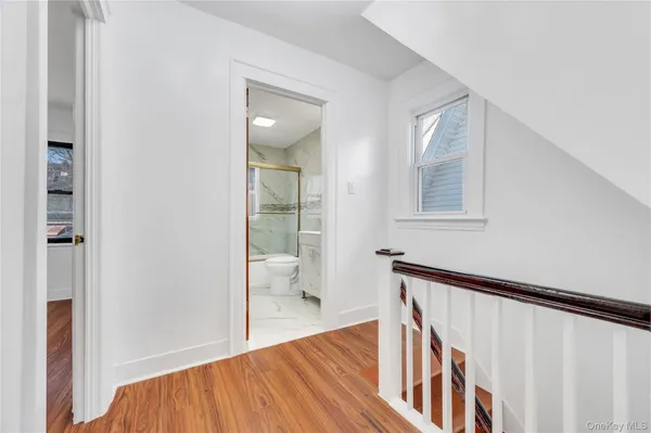 a view of an entryway with wooden floor