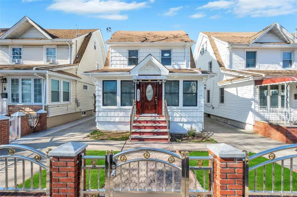 a front view of a house with a garden