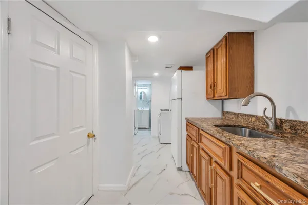 a spacious bathroom with a granite countertop sink and a mirror
