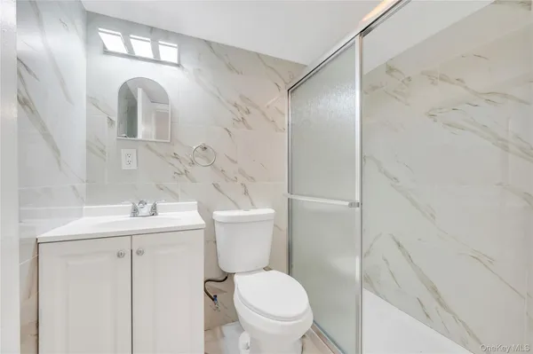 a bathroom with a sink toilet and vanity