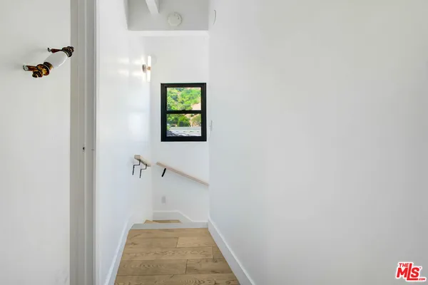 a view of a hallway with a wooden floor