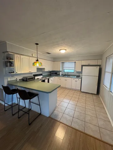 a kitchen with stainless steel appliances granite countertop a sink and a stove
