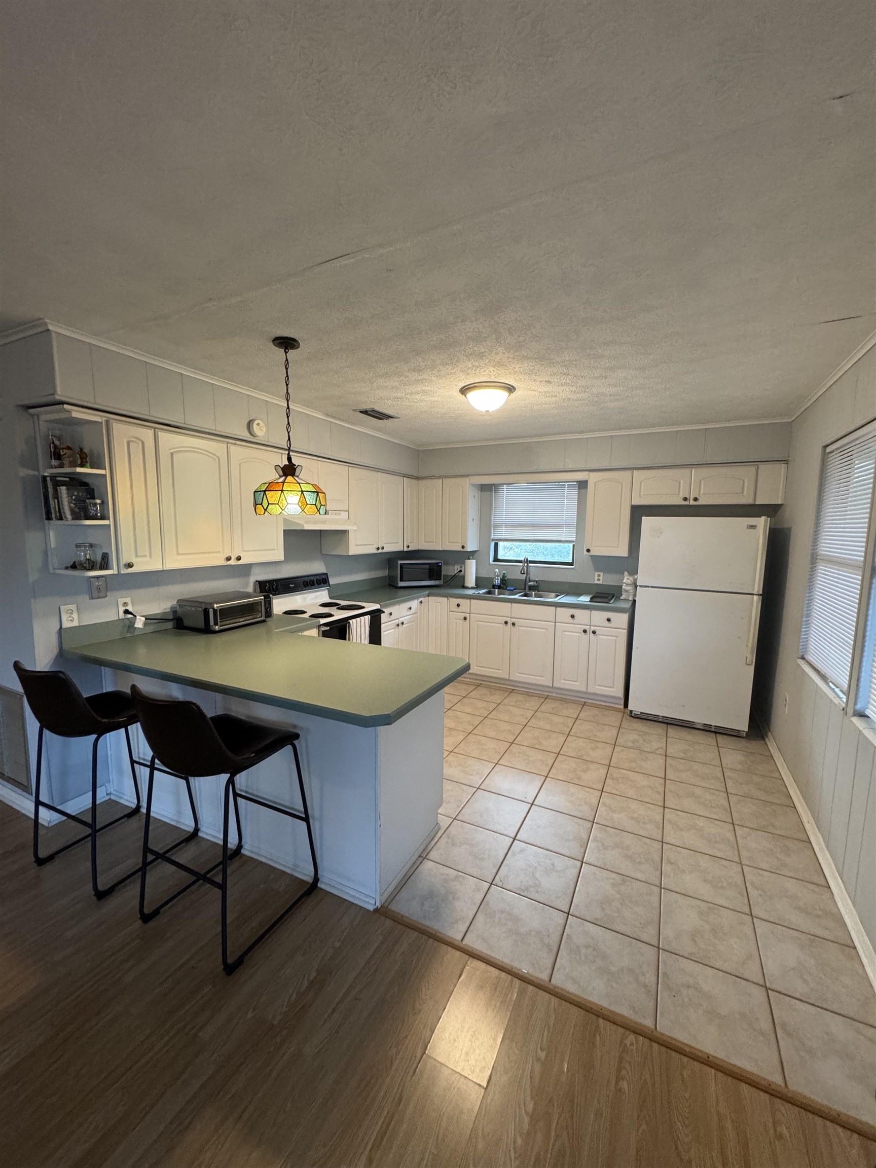 4939 Medoras Avenue St. Augustine, FL 32080 - Photo 3 of 17 a kitchen with stainless steel appliances granite countertop a sink and a stove