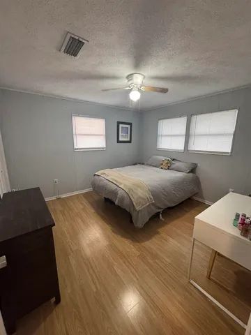 a bedroom with bed and window