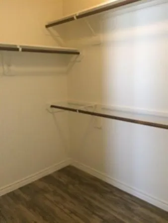 a view of a room with wooden floor