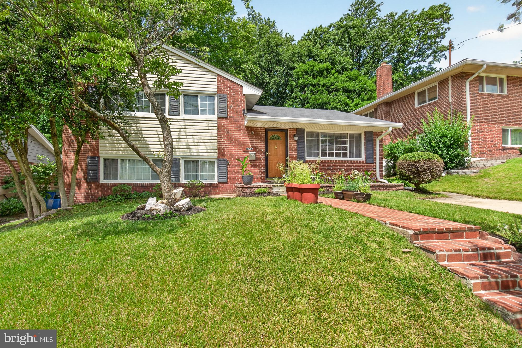 10202 Leslie Street Silver Spring, MD 20910 - Photo 3 of 44 Charming brick home with lush greenery.