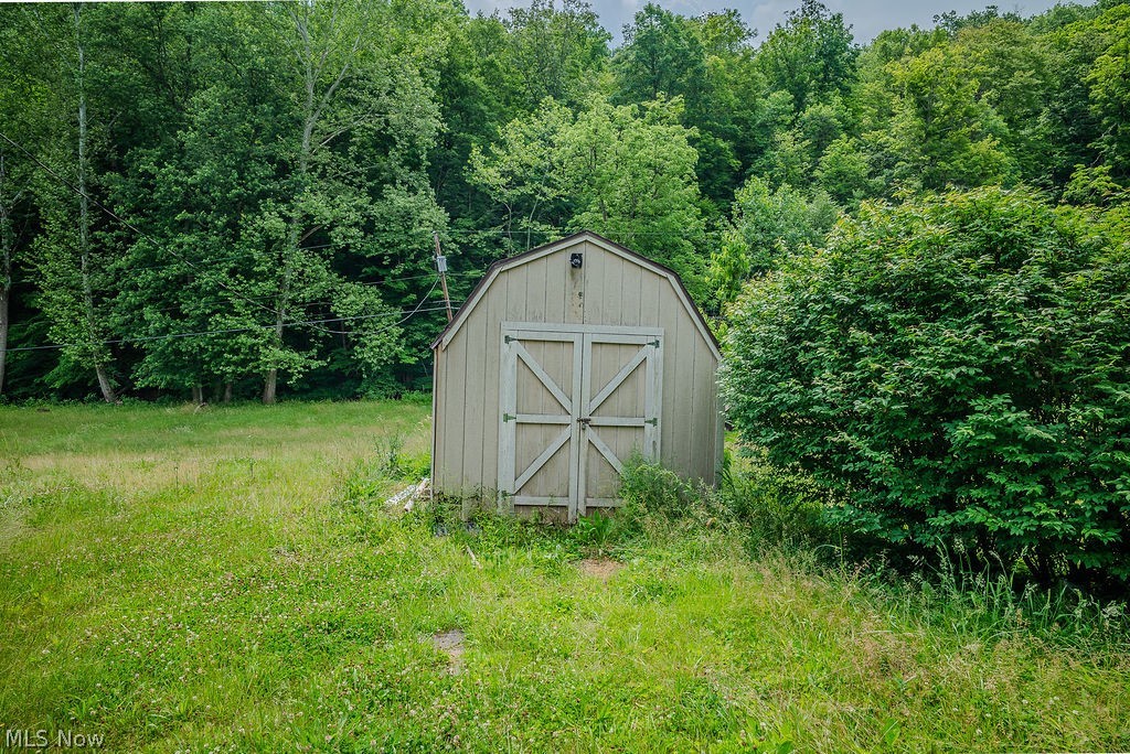967 Buck Run Road Mineral Wells, WV 26150 - Photo 47 of 50 Gable-roof storage shed featuring double barn doors and light-toned siding