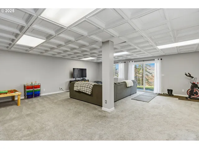 a bedroom with a bed and painting on the wall