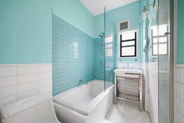 a bathroom with a tub toilet and sink