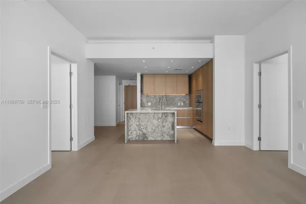 a view of kitchen with refrigerator and window