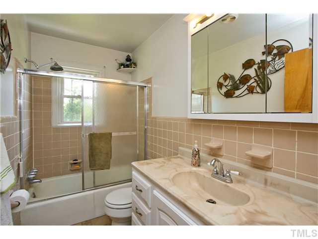 222 Santee Road Durham, NC 27704 - Photo 11 of 21 a bathroom with a sink a toilet and shower