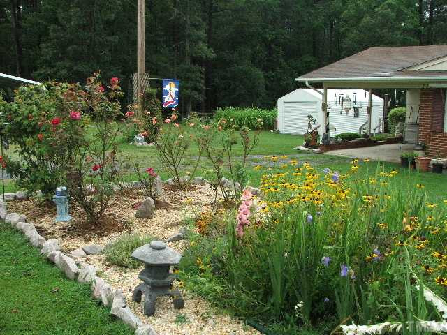 222 Santee Road Durham, NC 27704 - Photo 14 of 21 a view of a house with a yard and garden