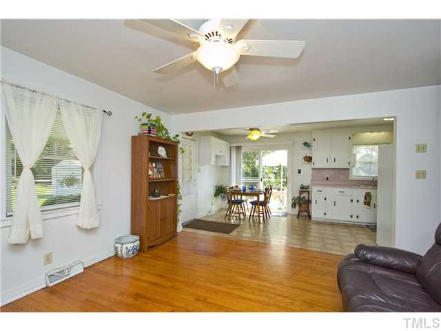 222 Santee Road Durham, NC 27704 - Photo 6 of 21 a living room with furniture and a large mirror