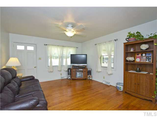 222 Santee Road Durham, NC 27704 - Photo 7 of 21 a living room with furniture and a flat screen tv