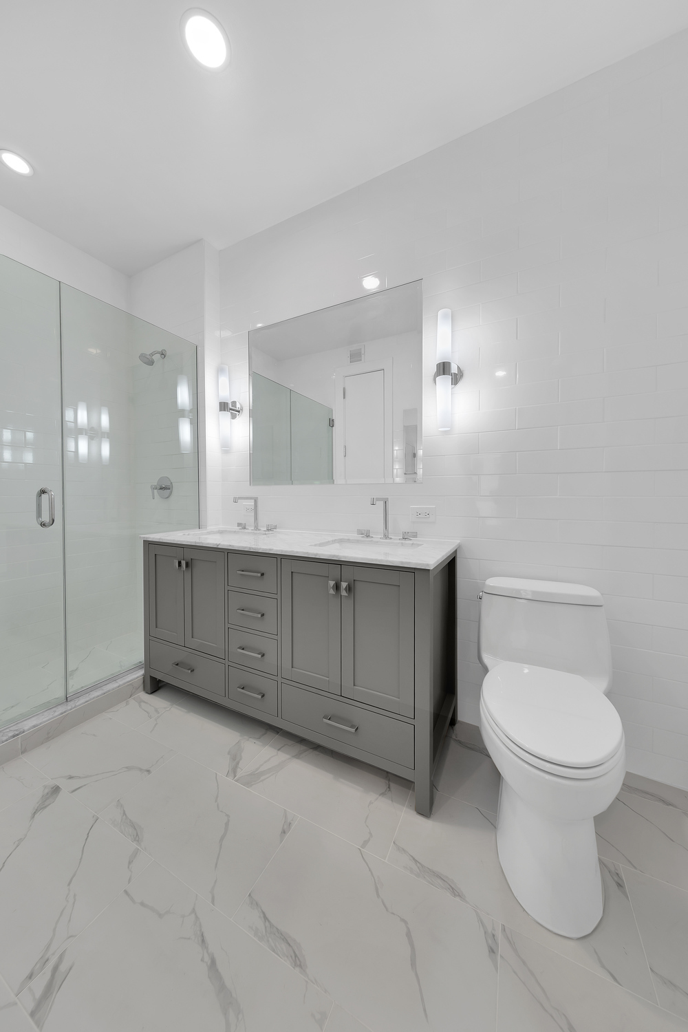 250 East 49th Street, Unit 3E Manhattan, NY 10017 - Photo 10 of 20 a bathroom with a granite countertop sink mirror and toilet