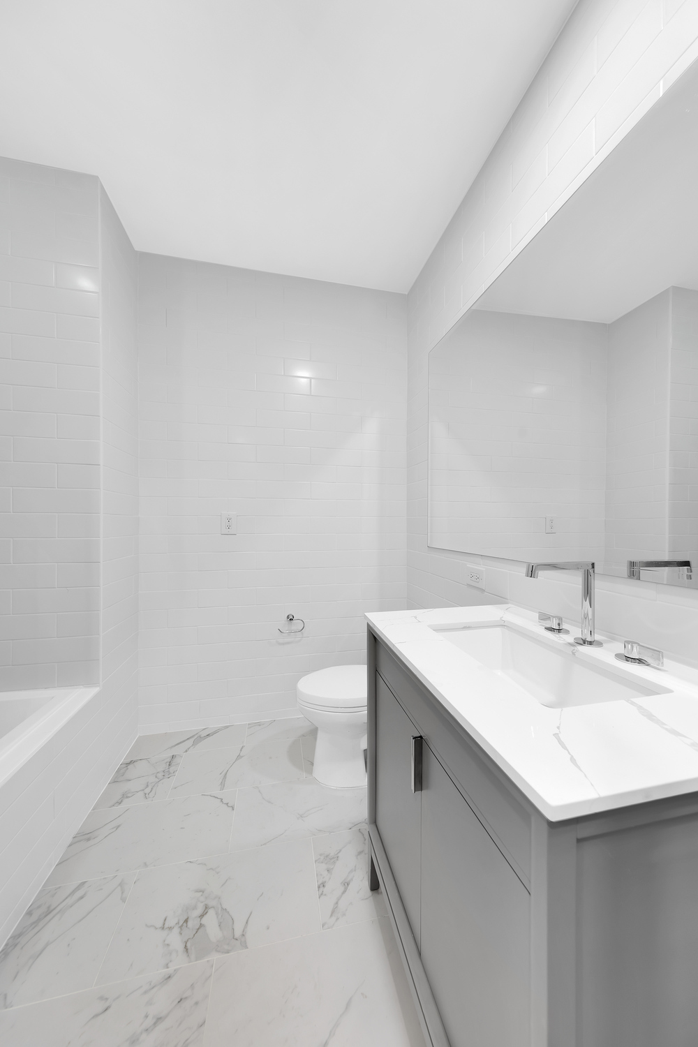 250 East 49th Street, Unit 3E Manhattan, NY 10017 - Photo 13 of 20 a bathroom with a sink toilet and vanity