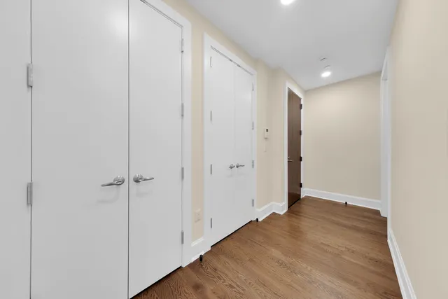 a view of hallway with wooden floor