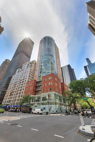 a view of a tall building next to a road