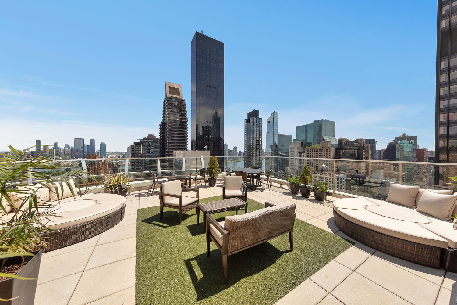 250 East 49th Street, Unit 3E Manhattan, NY 10017 - Photo 17 of 20 a roof deck with couches and potted plants with sky view