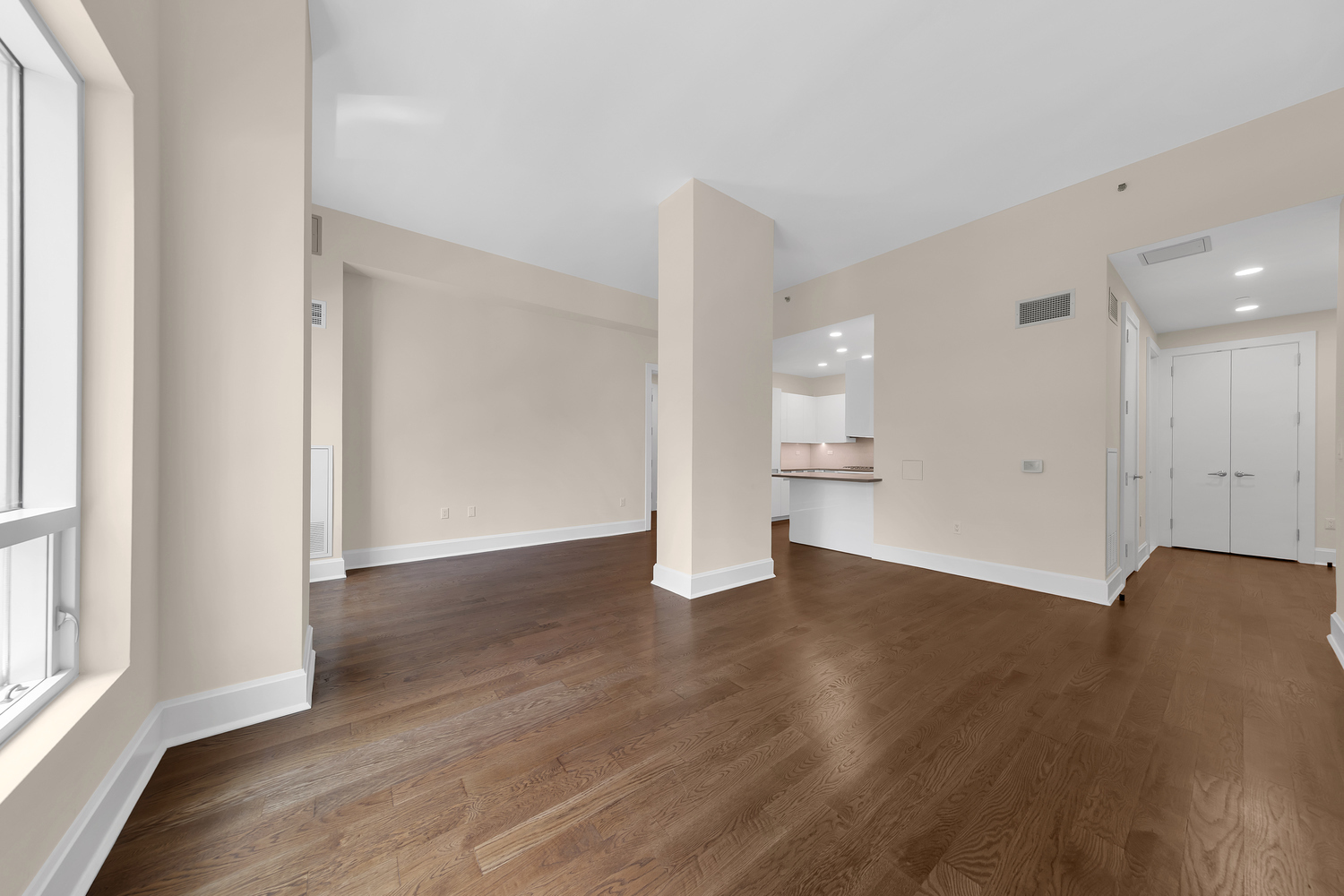 250 East 49th Street, Unit 3E Manhattan, NY 10017 - Photo 4 of 20 a view of an empty room with wooden floor and a window