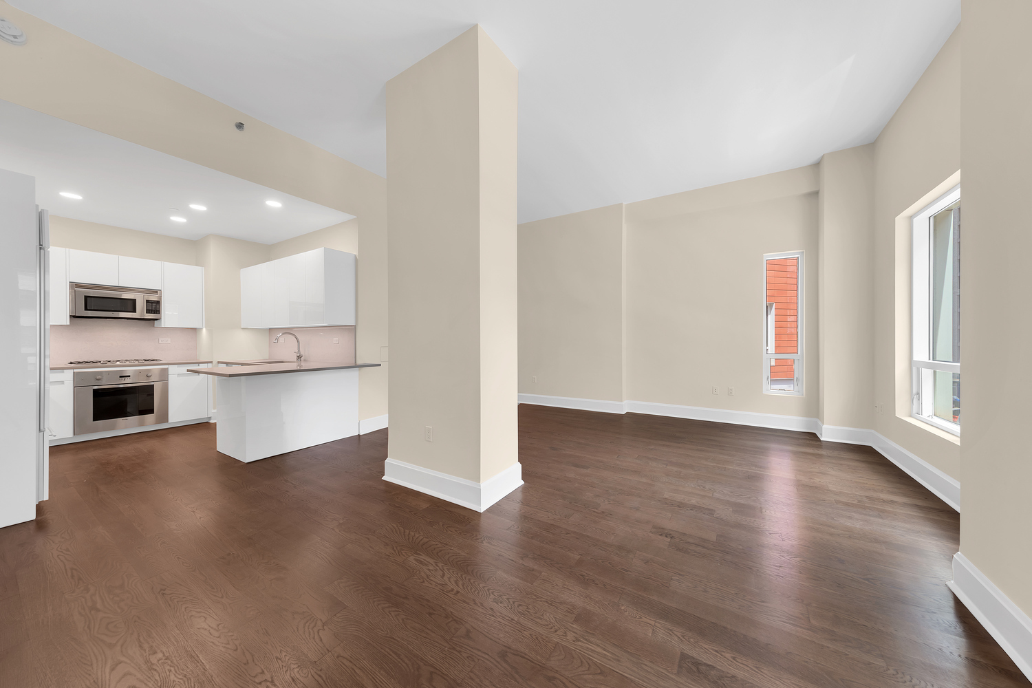 250 East 49th Street, Unit 3E Manhattan, NY 10017 - Photo 6 of 20 a view of a kitchen with wooden floor and a refrigerator