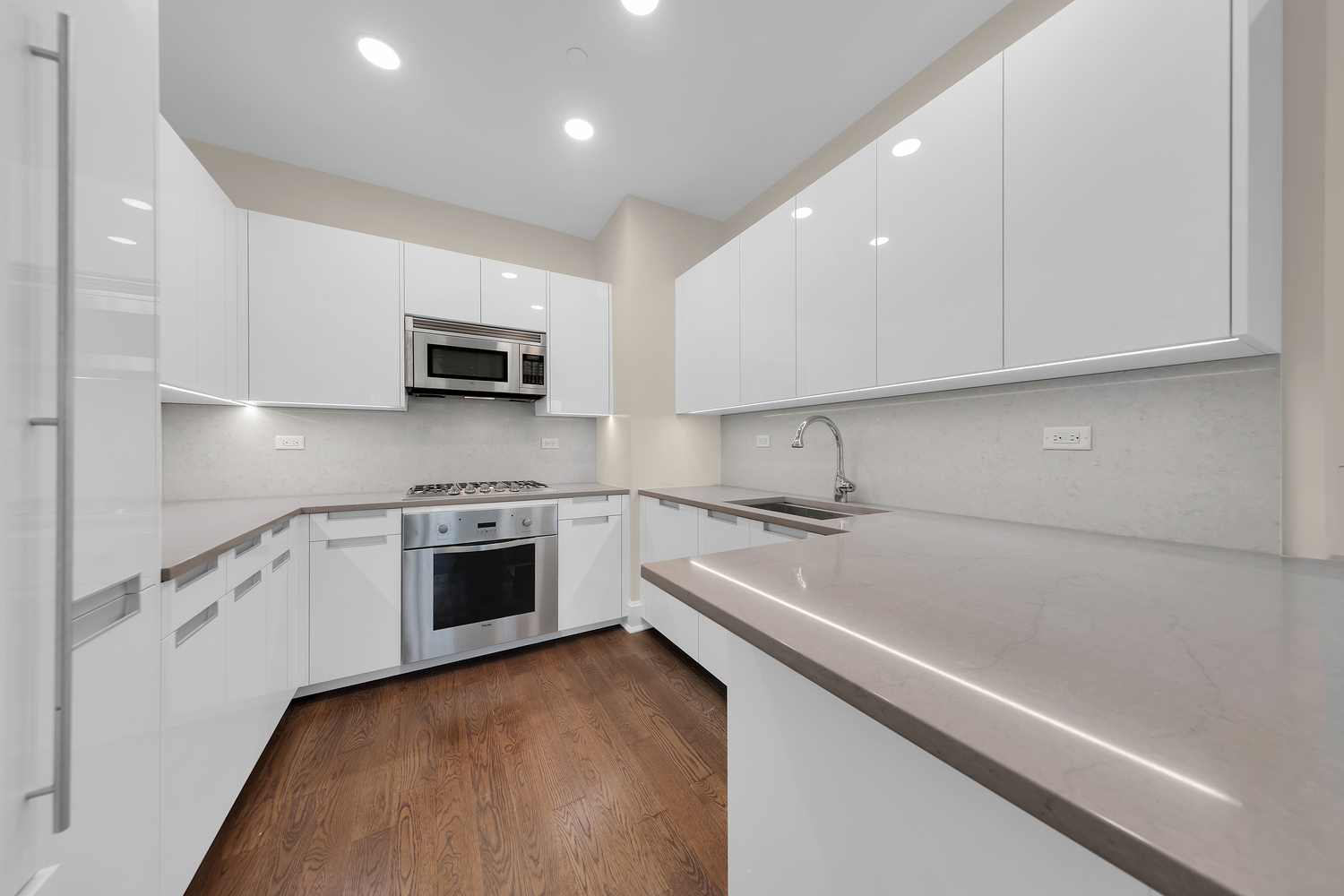 250 East 49th Street, Unit 3E Manhattan, NY 10017 - Photo 7 of 20 a kitchen with stainless steel appliances a stove a sink and a microwave