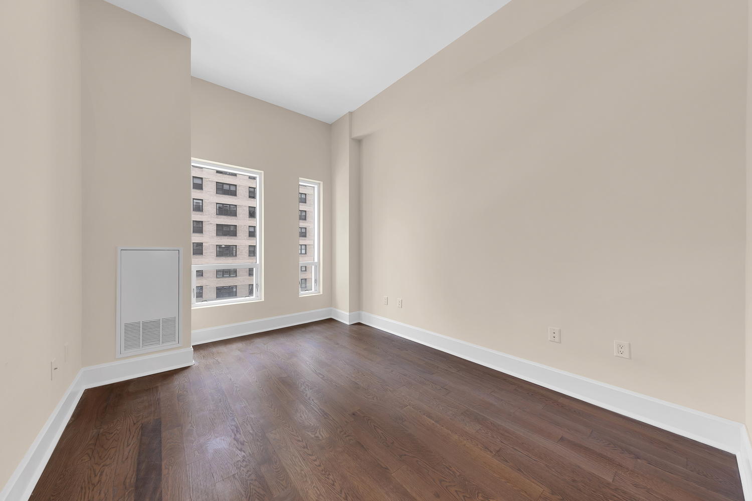 250 East 49th Street, Unit 3E Manhattan, NY 10017 - Photo 9 of 20 an empty room with wooden floor and windows