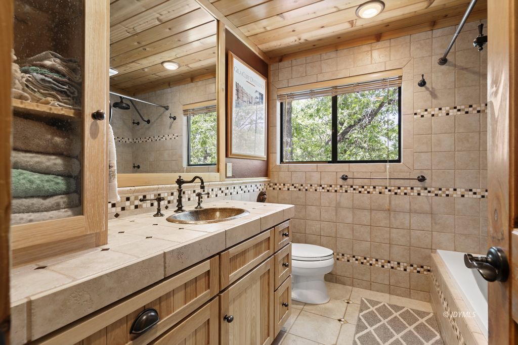 25575 Sunrise Drive Idyllwild, CA 92549 - Photo 21 of 35 a bathroom with a sink a toilet and a large mirror