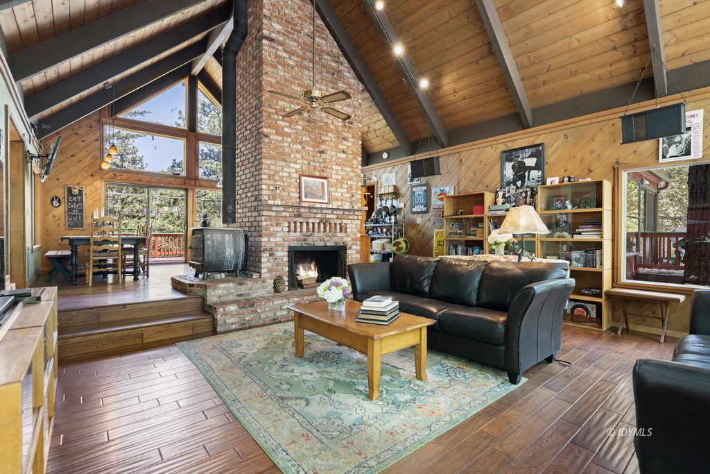25575 Sunrise Drive Idyllwild, CA 92549 - Photo 4 of 35 a living room with furniture a fireplace and a table
