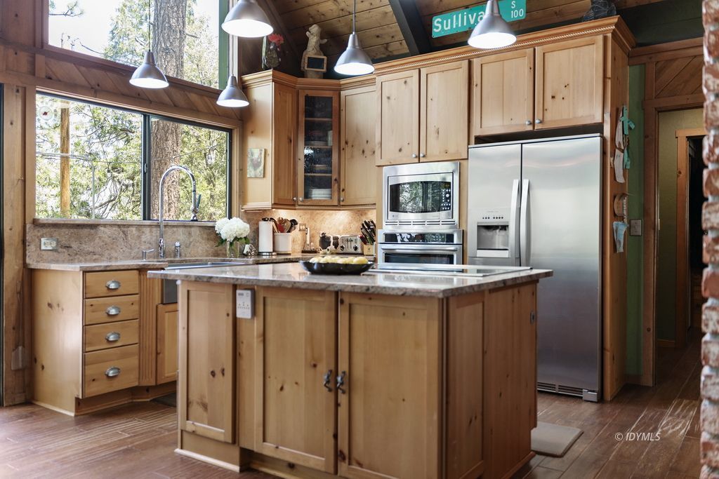 25575 Sunrise Drive Idyllwild, CA 92549 - Photo 10 of 35 a kitchen with stainless steel appliances granite countertop a refrigerator sink and cabinets
