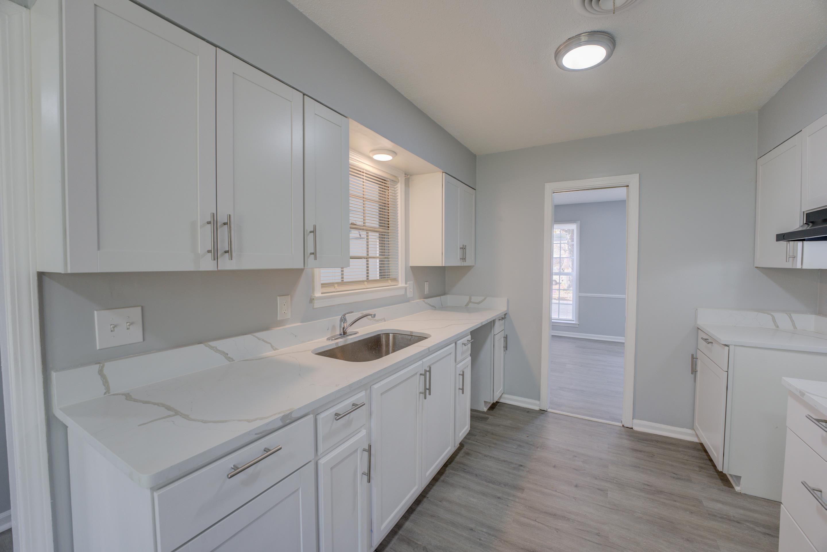3482 Clarke Road Memphis, TN 38115 - Photo 12 of 29 a kitchen with a sink cabinets and wooden floor