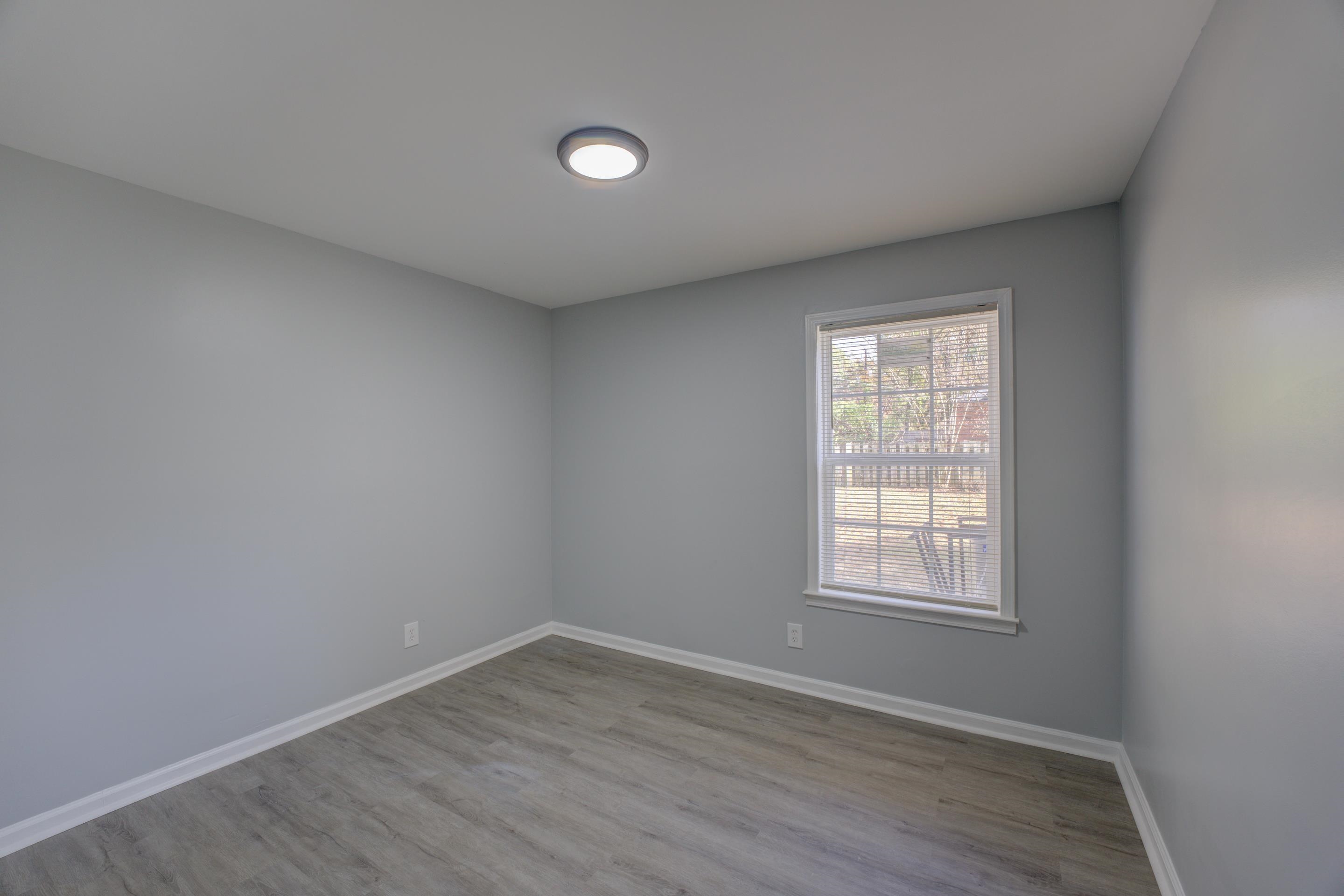 3482 Clarke Road Memphis, TN 38115 - Photo 21 of 29 an empty room with wooden floor and windows