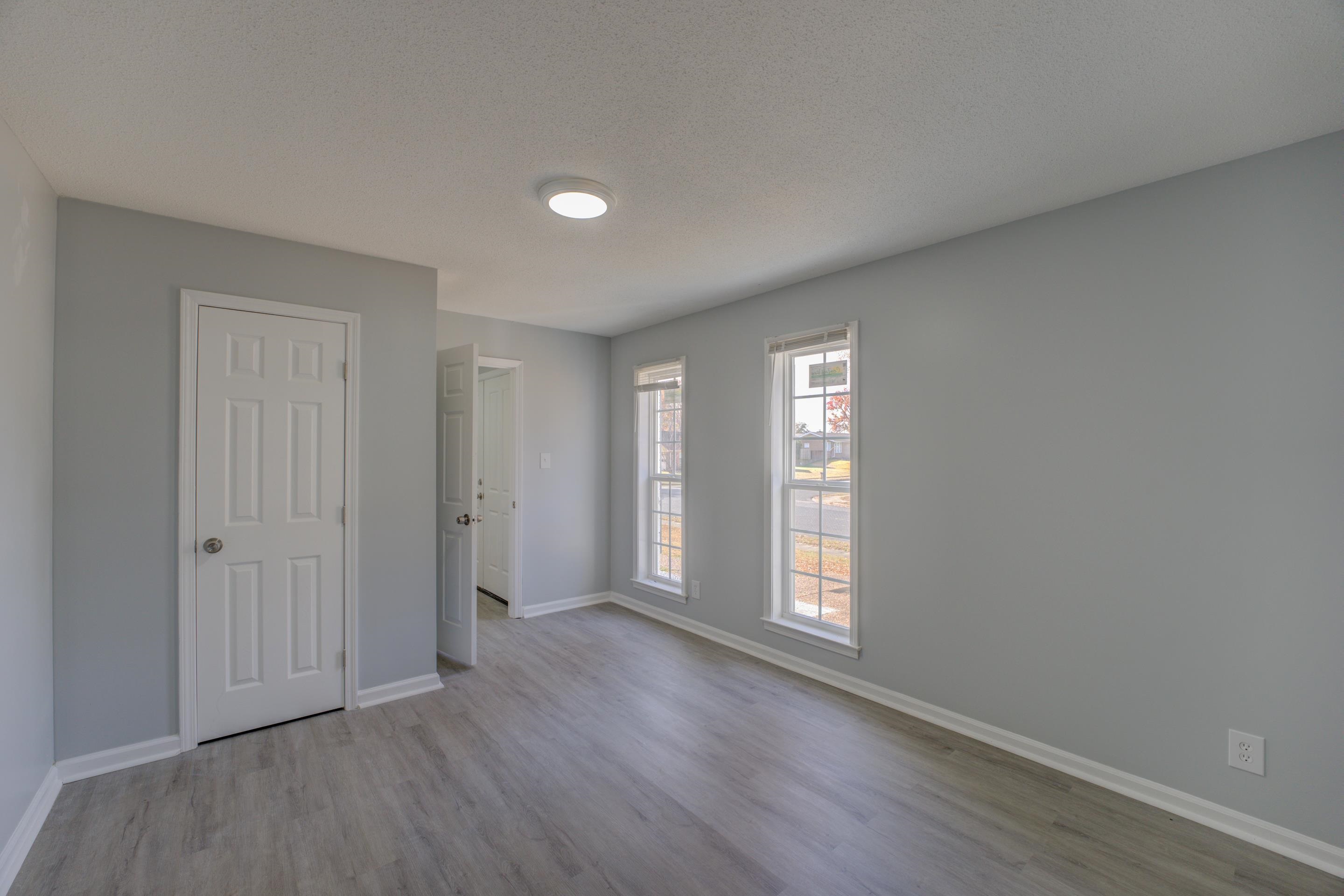3482 Clarke Road Memphis, TN 38115 - Photo 24 of 29 a view of an empty room with wooden floor and window