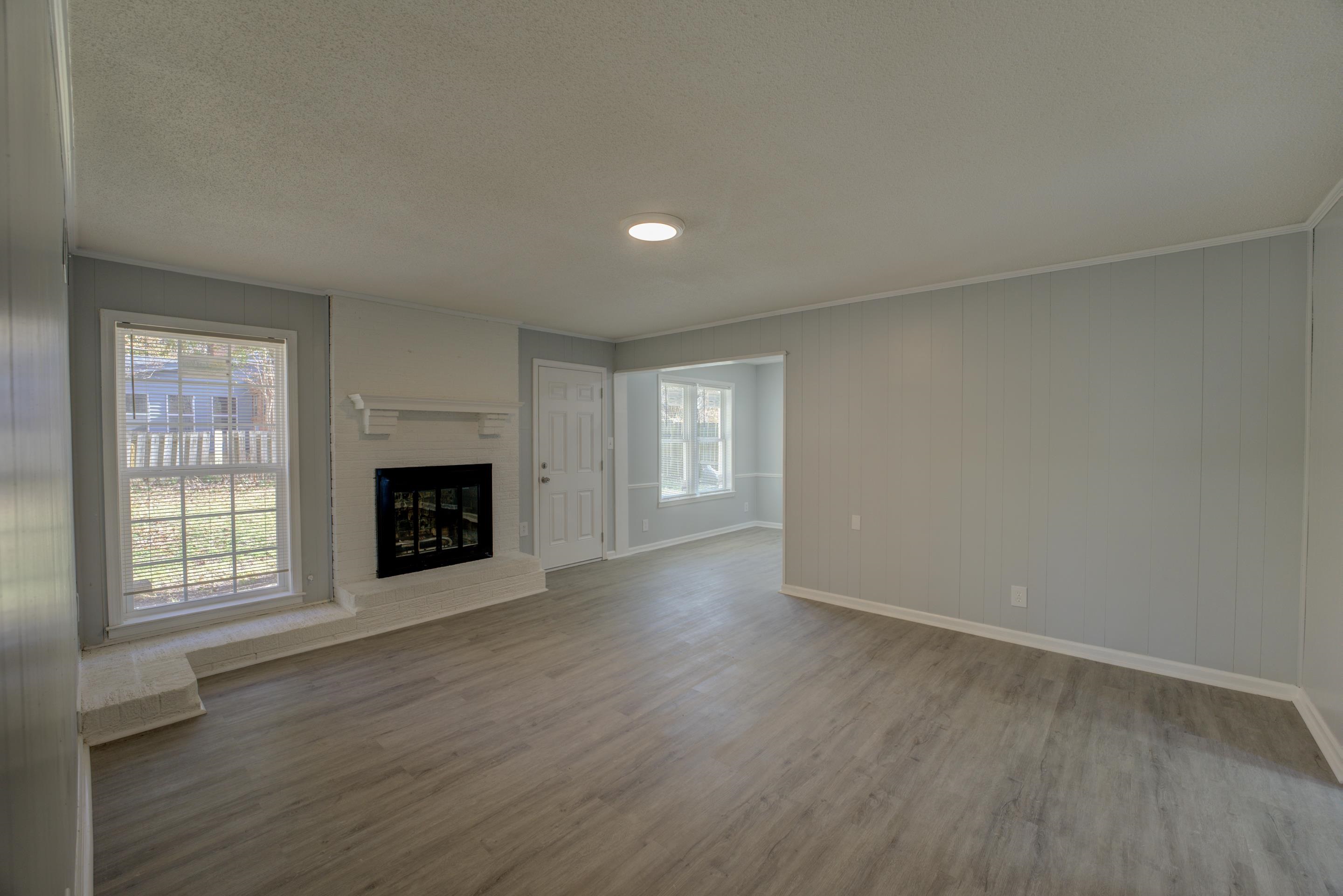 3482 Clarke Road Memphis, TN 38115 - Photo 6 of 29 an empty room with windows and fireplace