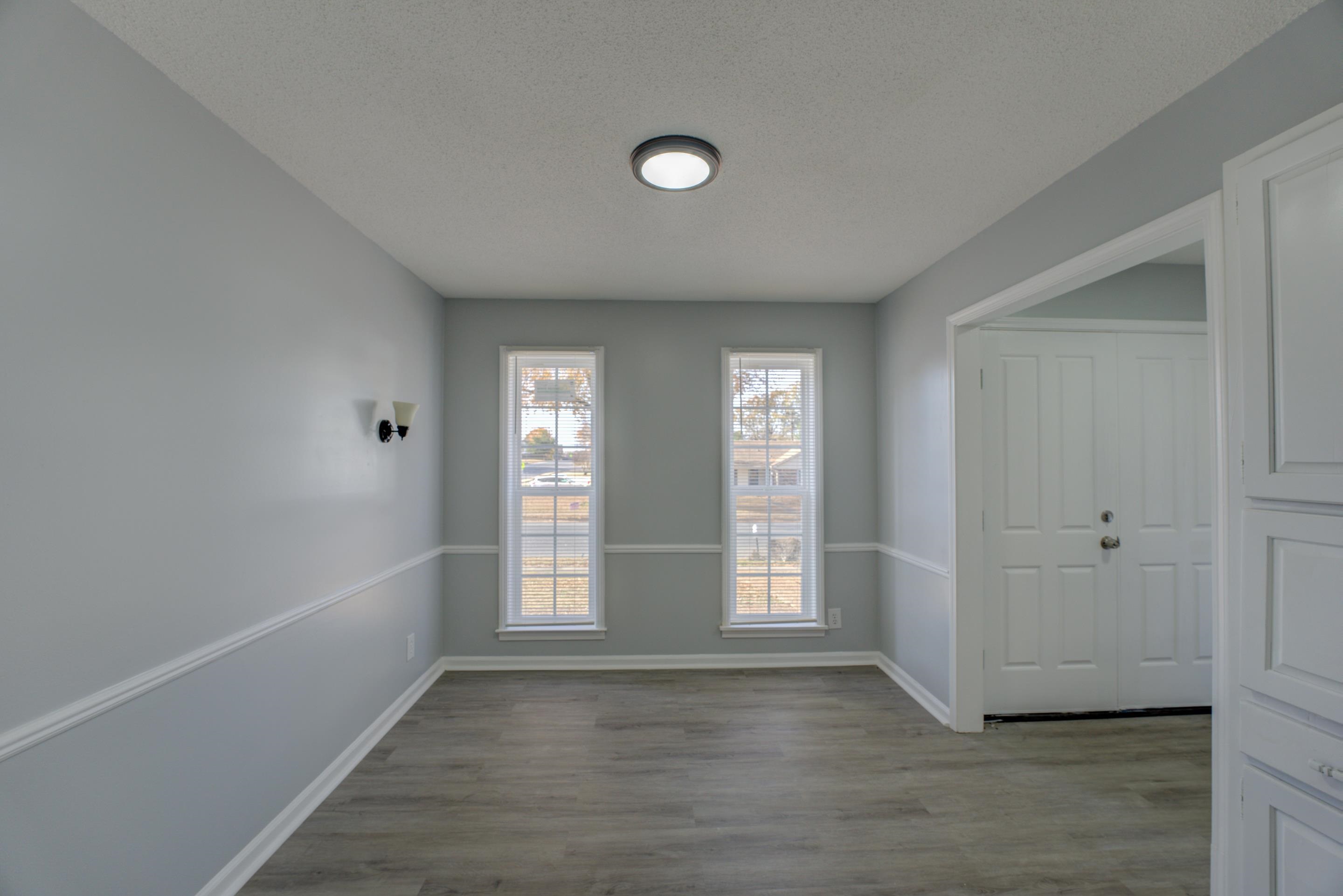 3482 Clarke Road Memphis, TN 38115 - Photo 9 of 29 an empty room with wooden floor and windows