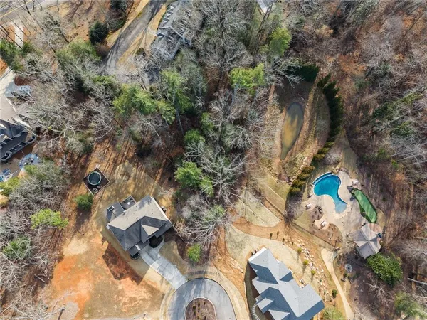 a view of a house with swimming pool and sitting area