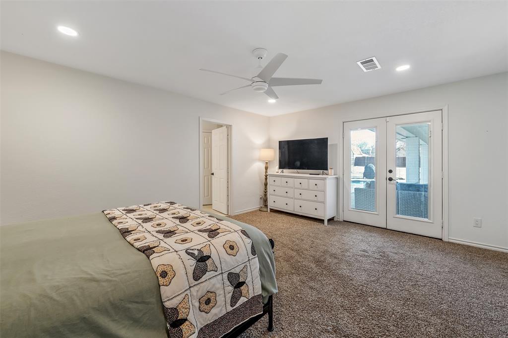 300 Rash Lane Terrell, TX 75160 - Photo 13 of 28 a spacious bedroom with a bed and a view of kitchen