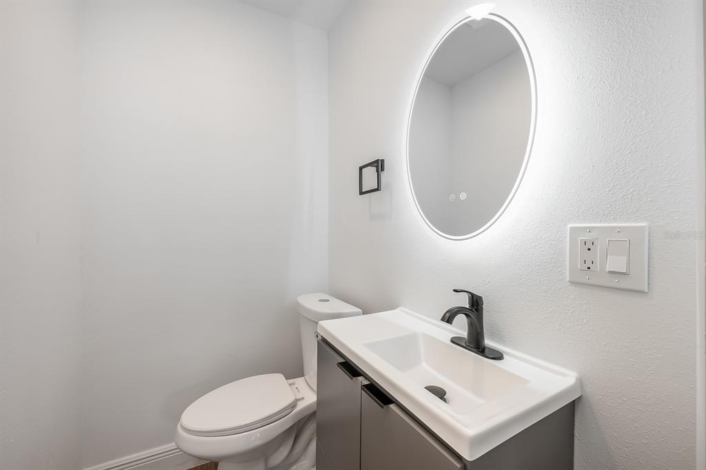 109 Magnolia Avenue Seffner, FL 33584 - Photo 40 of 46 a white toilet sitting next to a bathroom sink