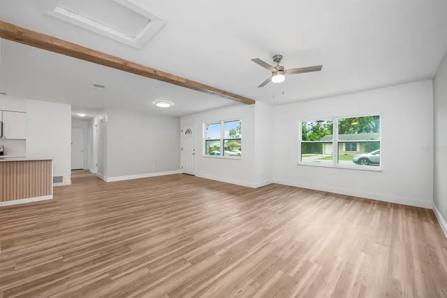 a view of empty room with wooden floor
